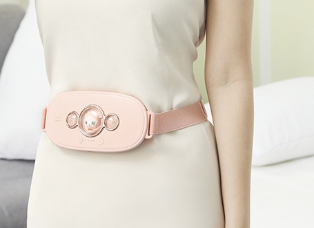 N1 warming belt worn over clothing with side strap visible